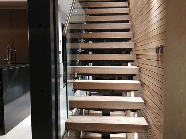 Made-To-Measure Staircases 1 Stylish contemporary glass steel staircase blending wood and glass with a single spine steel support, adding sophistication and modernity to the home interior.