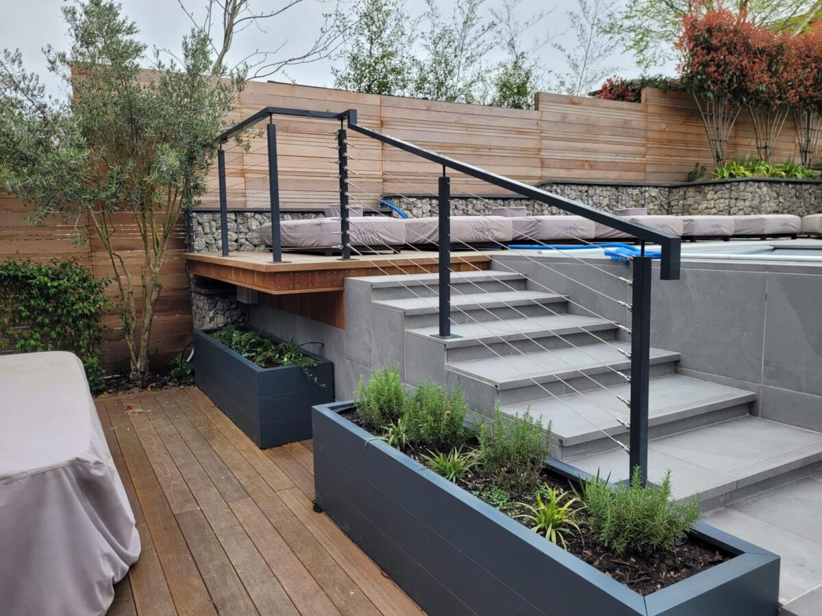 Balustrades 6 Modern outdoor deck featuring a post and wire balustrade system with sleek metal posts and cables, enhancing the contemporary design of the multi-level terrace and providing safety and style.