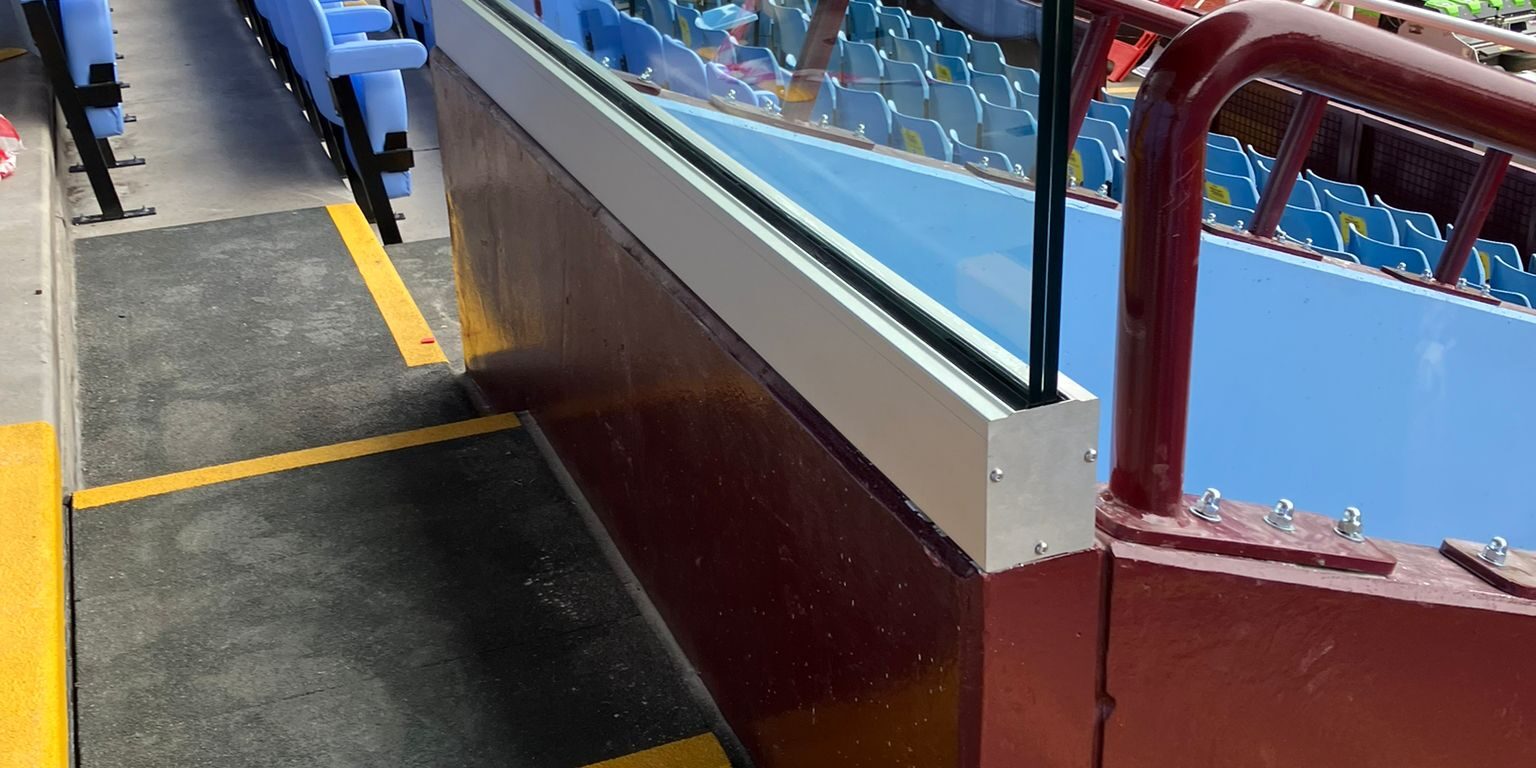 Aston Villa Installation of 25.5mm laminate glass and track system at Aston Villa Football Ground, providing a clear, secure barrier between the stands and the pitch.