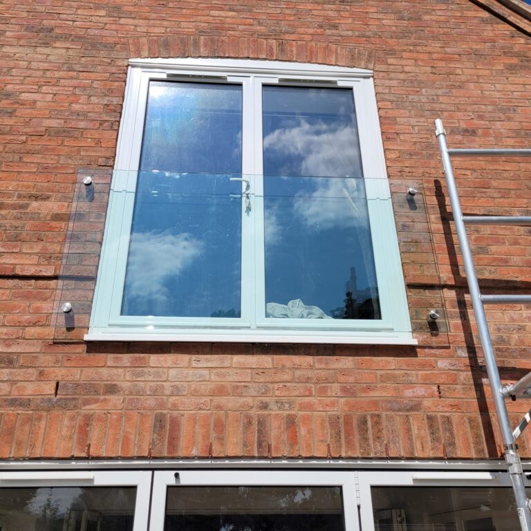 WhatsApp Image 2024-08-08 at 11.18.05_eae58cdd Frameless Juliet balcony installation in Rugby with clear toughened glass secured by stainless steel adaptors.