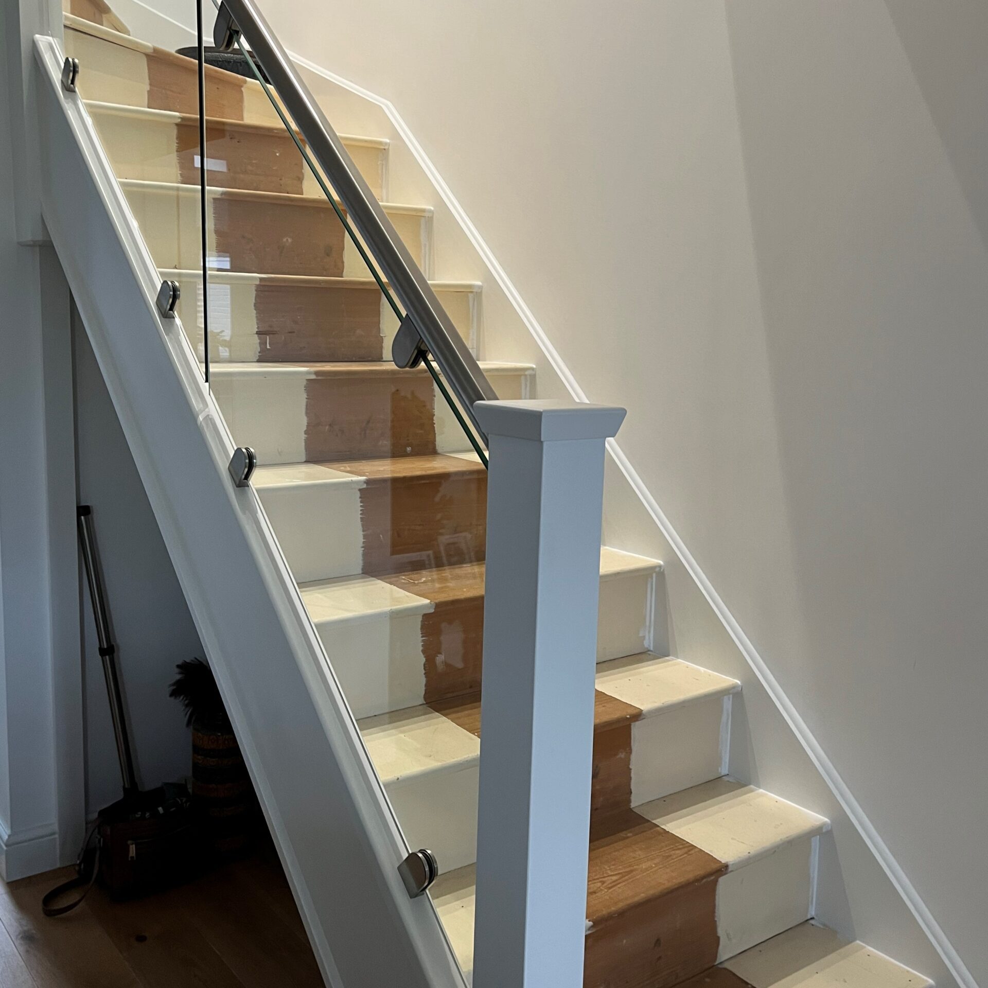 Glass Staircase Banisters 5 Elegant staircase with clamps, featuring frosted glass panels and a sleek metal handrail, providing both privacy and a contemporary look.