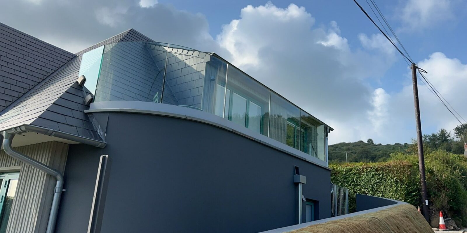 Stunning frameless glass balustrade enhancing outdoor living space in West Wales.