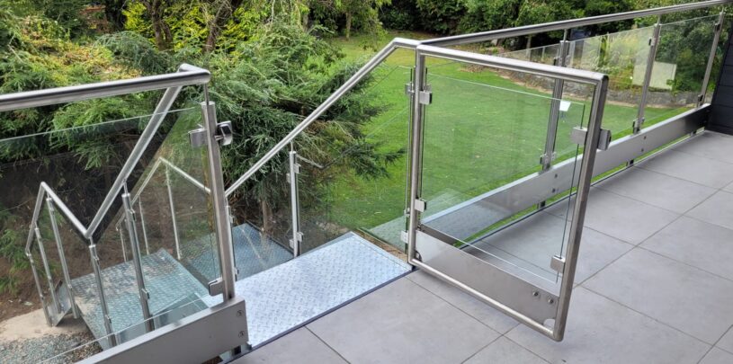 Post and glass balustrade with gate in a modern home installation