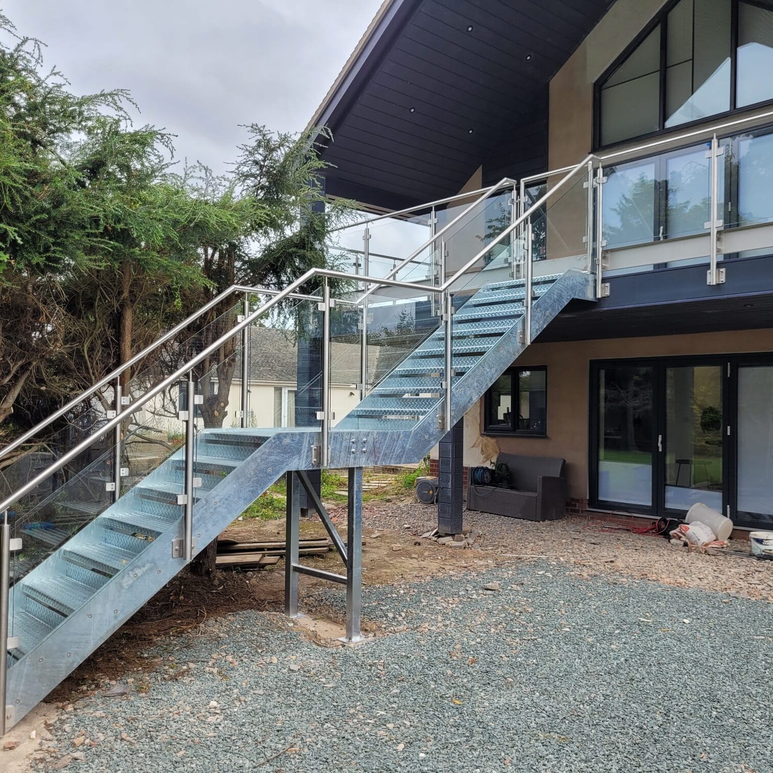 Structural Steel Balconies 1 View from a balcony with post and glass balustrade and gate