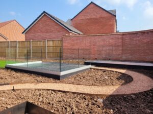 Frameless glass balustrade surrounding an outdoor patio area