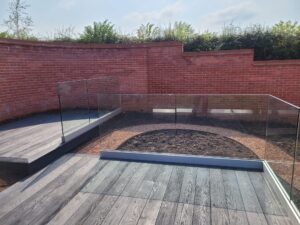 Base fixed glass balustrade with sleek design in a modern Shropshire garden