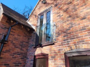 Close-up view of a sleek glass balustrade with side-fix posts and a handrail, enhancing outdoor views.
