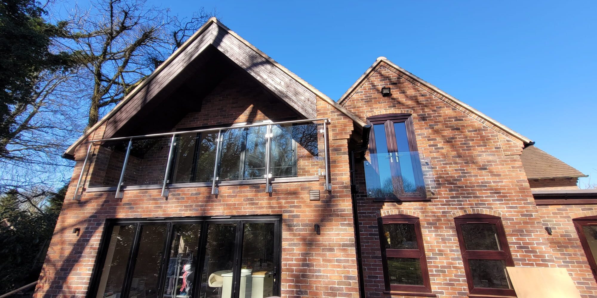 Stainless steel and glass balustrade installed on a balcony in Telford, providing modern safety and style.