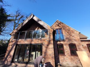 Stainless steel and glass balustrade installed on a balcony in Telford, providing modern safety and style.
