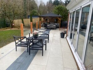 Full view of a modern patio featuring a timber post glass balustrade installation.