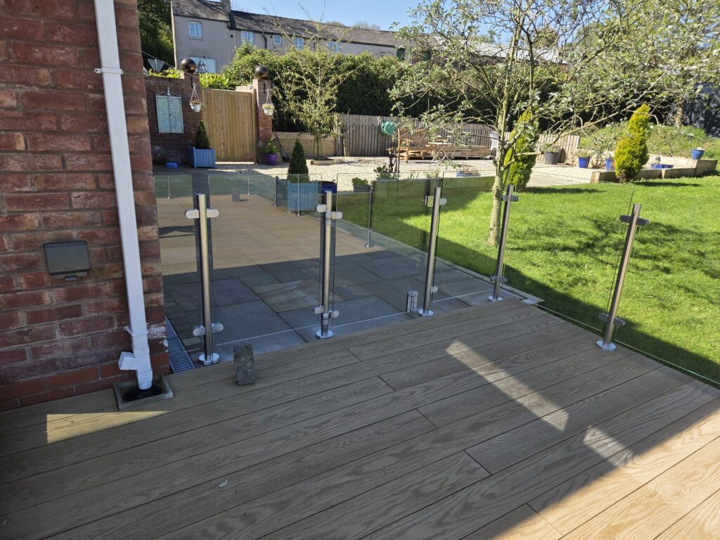 Modern garden decking fitted with clear glass balustrades