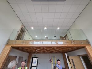 frameless glass balustrade with boss side fixing in office space - internal view