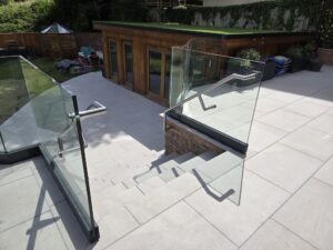clean glass balustrade installation on outdoor stairway with steel handrails