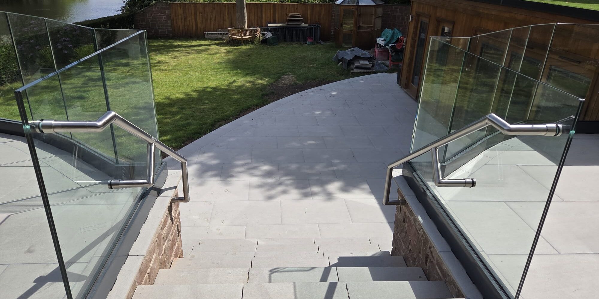 IMG-20250724-WA0040 frameless glass balustrade with stainless steel handrails on garden steps