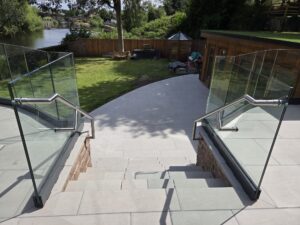 frameless glass balustrade with stainless steel handrails on garden steps
