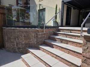 side view of outdoor steps with stainless handrail and frameless glass balustrade