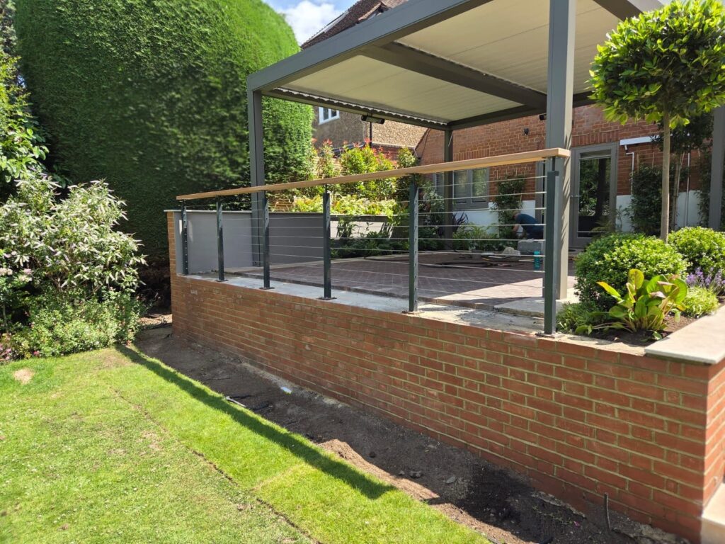 Wire balustrade with timber handrail in modern garden powder coated back view Wire balustrade with timber handrail in modern garden powder coated back view