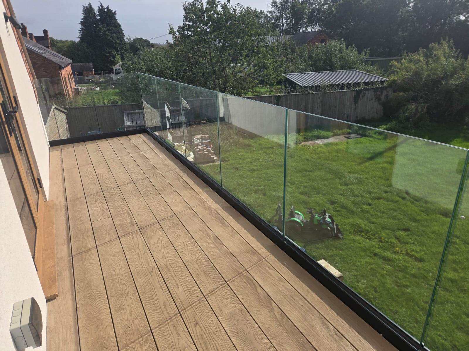 Powder-coated Vision Elegence glass track at the edge of a timber platform